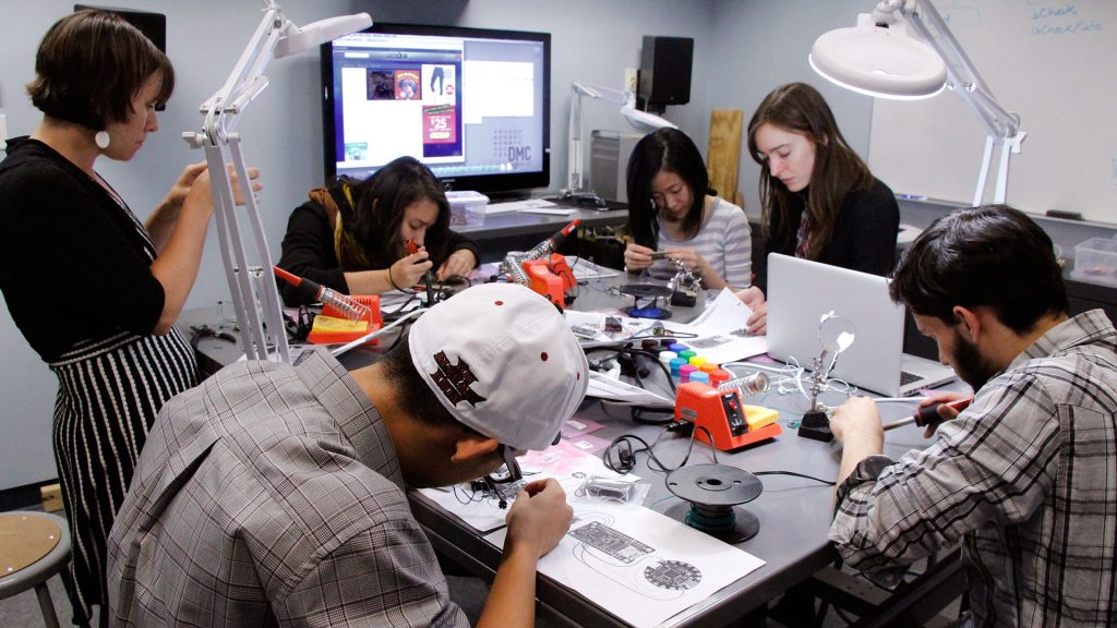 Students working on various projects as part of a maker workshop