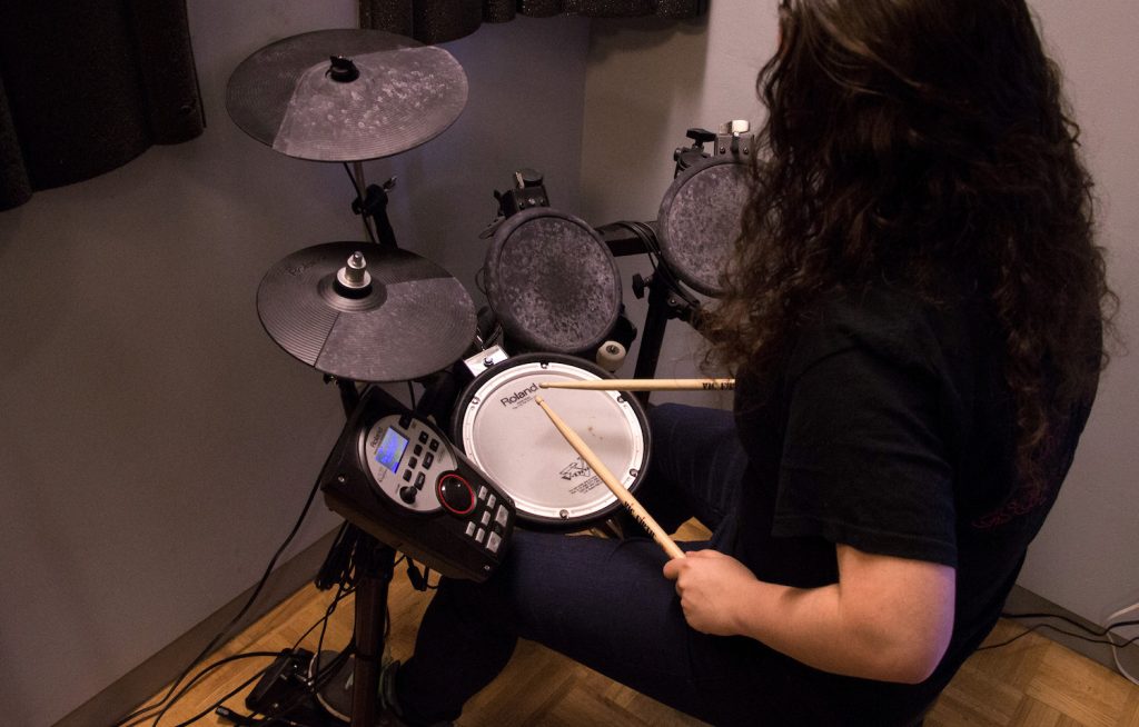 Student using the electronic drums