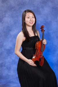 Alice Huang holding violin.