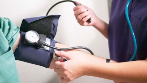 A healthcare provider checking a patient's blood pressure.