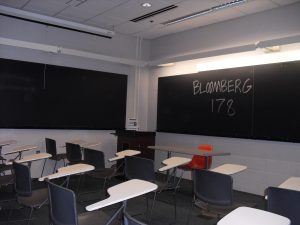 Empty classroom showing individual desk and chair seating.