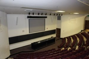 Large empty lecture classroom with theater style seating.