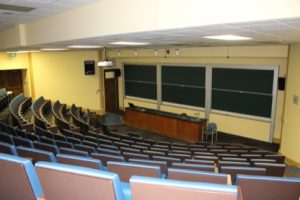 Large empty lecture classroom showing theater seating.