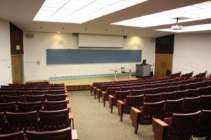 View of an empty lecture room and student seating.