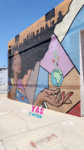 Mural of black girl with afro with the globe in her hand