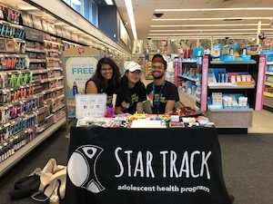 Chanel and two coworkers at a STAR TRACK table