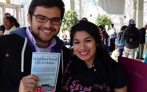 Students holding Neighborhood Open House brochure.