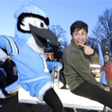 Student riding seesaw with Blue Jay