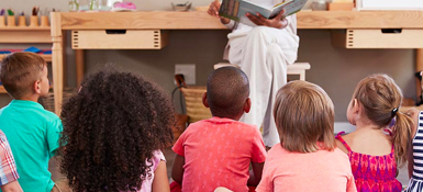 Children sitting in a classroom.
