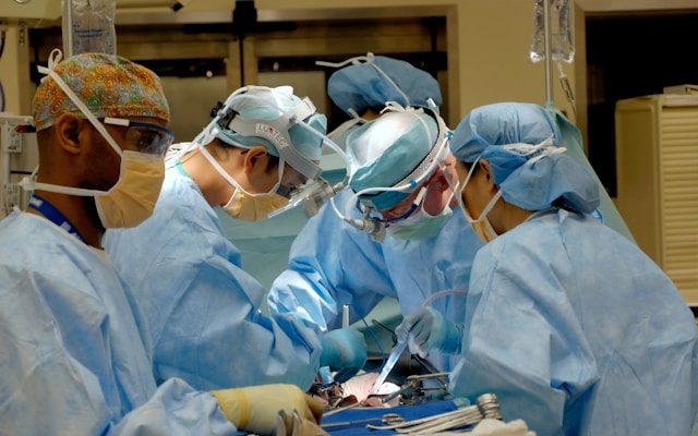 A full-color picture of doctors and nurses in an operating theater, performing surgery on a patient.