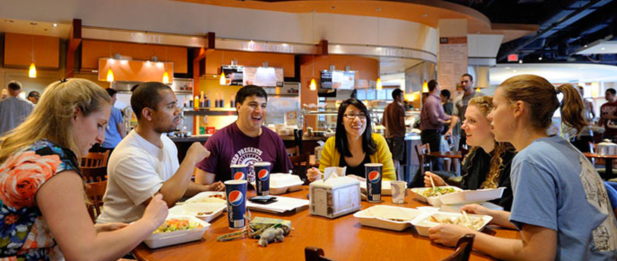 Students laughing and eating in Nolan's