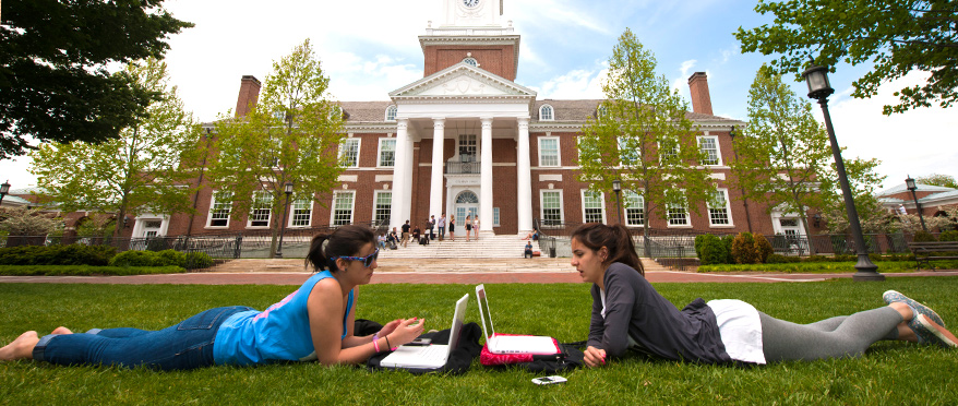Students laying on quad with laptops