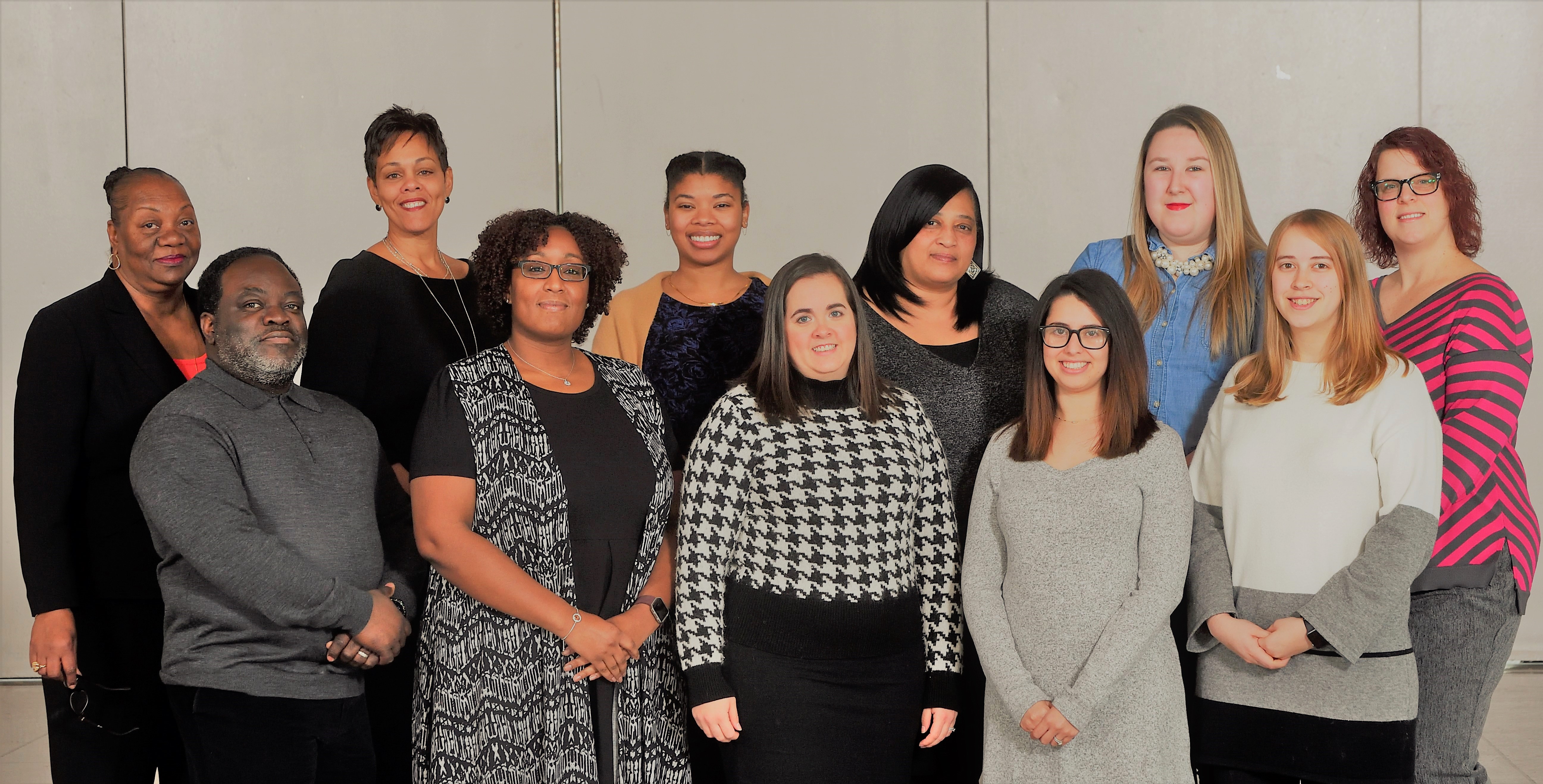 The staff stand together to pose for a picture.