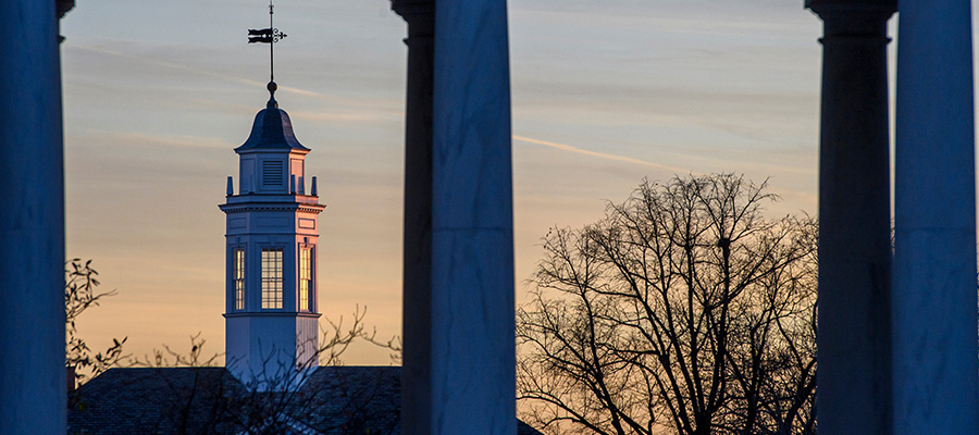 A view of Gilman Tower from the Breezeway at dusk