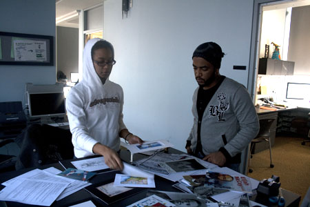 Two students work on "Roots of American Innovation" digital prints in the DMC