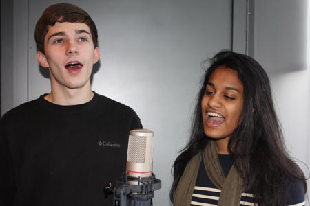 Singers Josh Temple and Meera Valliath sing "I See the Light" in the DMC recording studio