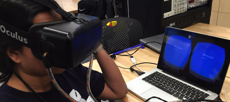 A student wears large virtual reality headgear.