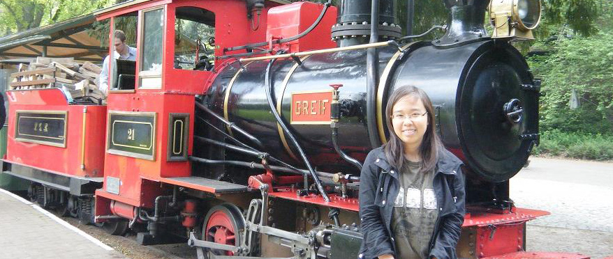Alane posing in front of a train