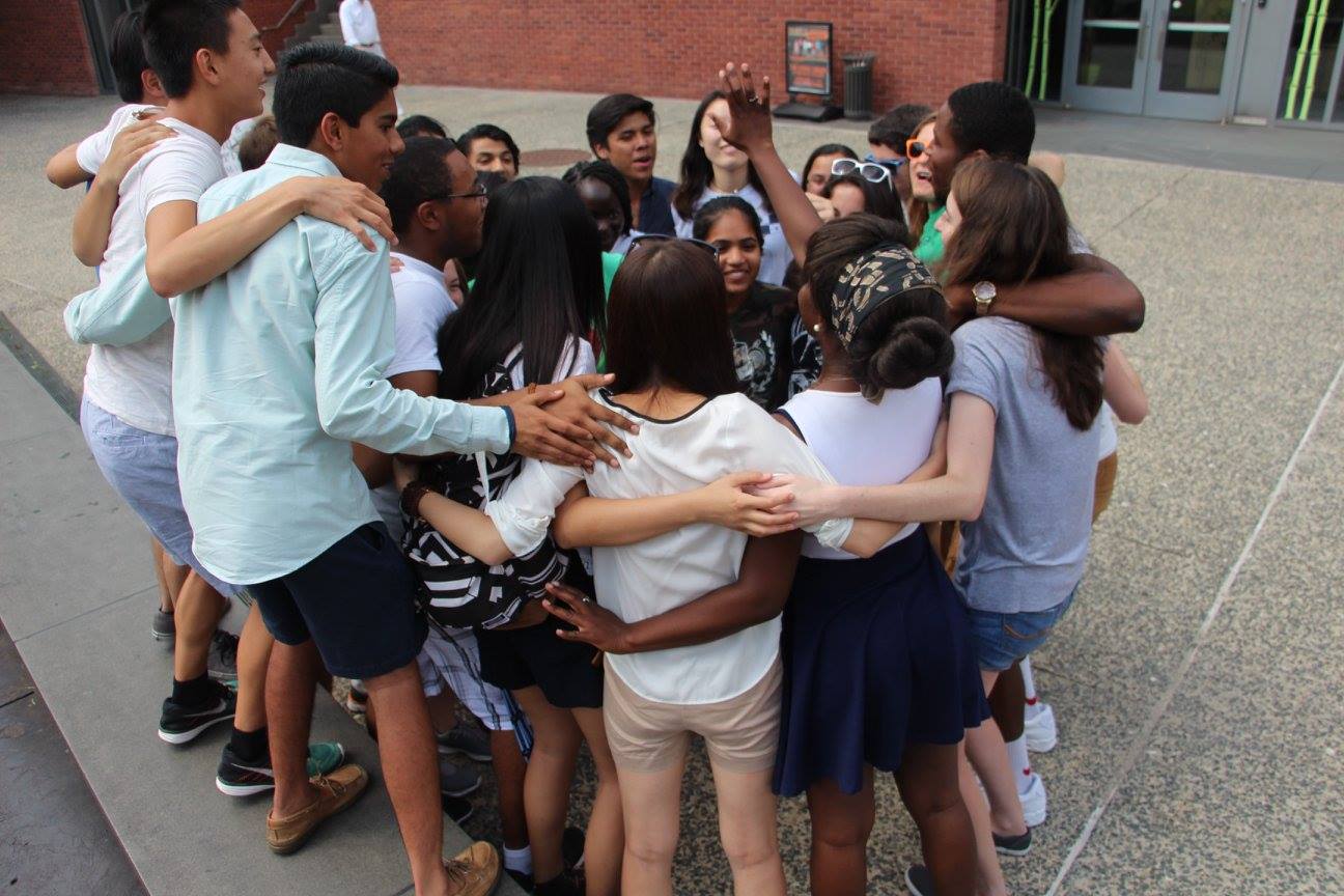 Students participating in a leadership program share a group hug. Students can nominate their peers for student leadership awards.