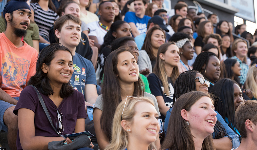 Students sit in the stands at Homewood Field during an event