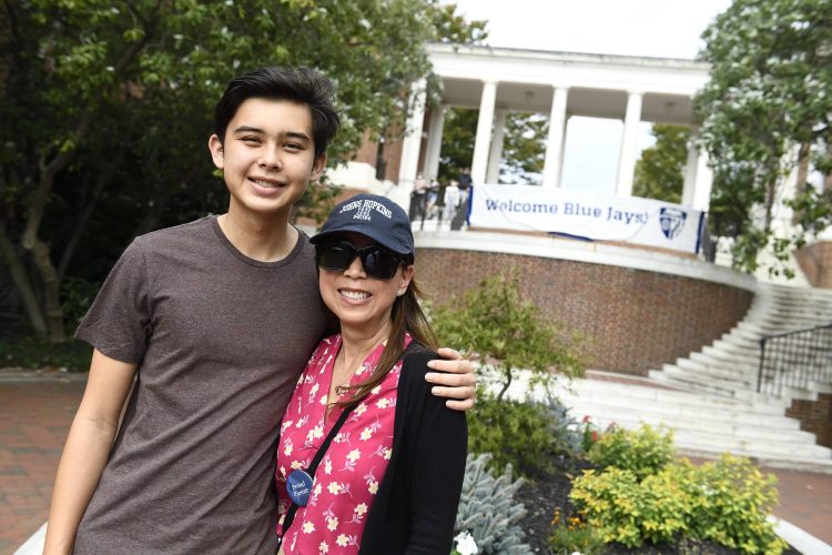 A student poses with his mother on Family Weekend 2021.