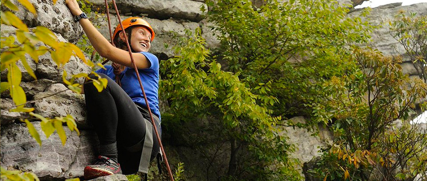 Girl smiles while climbing