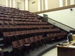 An empty Krieger 205 lecture room showing theater seating.