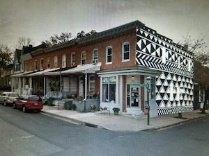 Rowhouses, end house has a black and white pattern mural