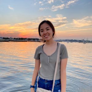 Photo of Stacey Tang, one of the 2022 CIIP peer mentors, smiling in front of an ocean sunset