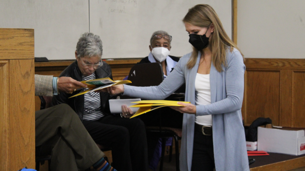 Dr. Victoria Harms passing out materials during her Fall 2022 semester class