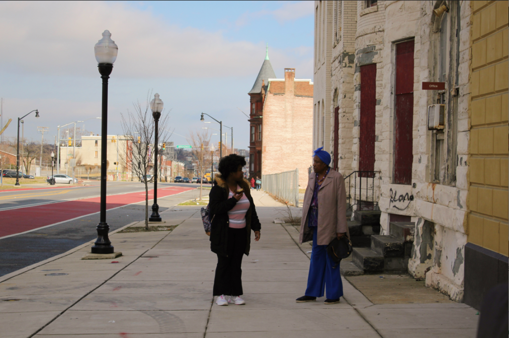 Dr. Joanne Martin and a student talking outside the museum in Baltimore City