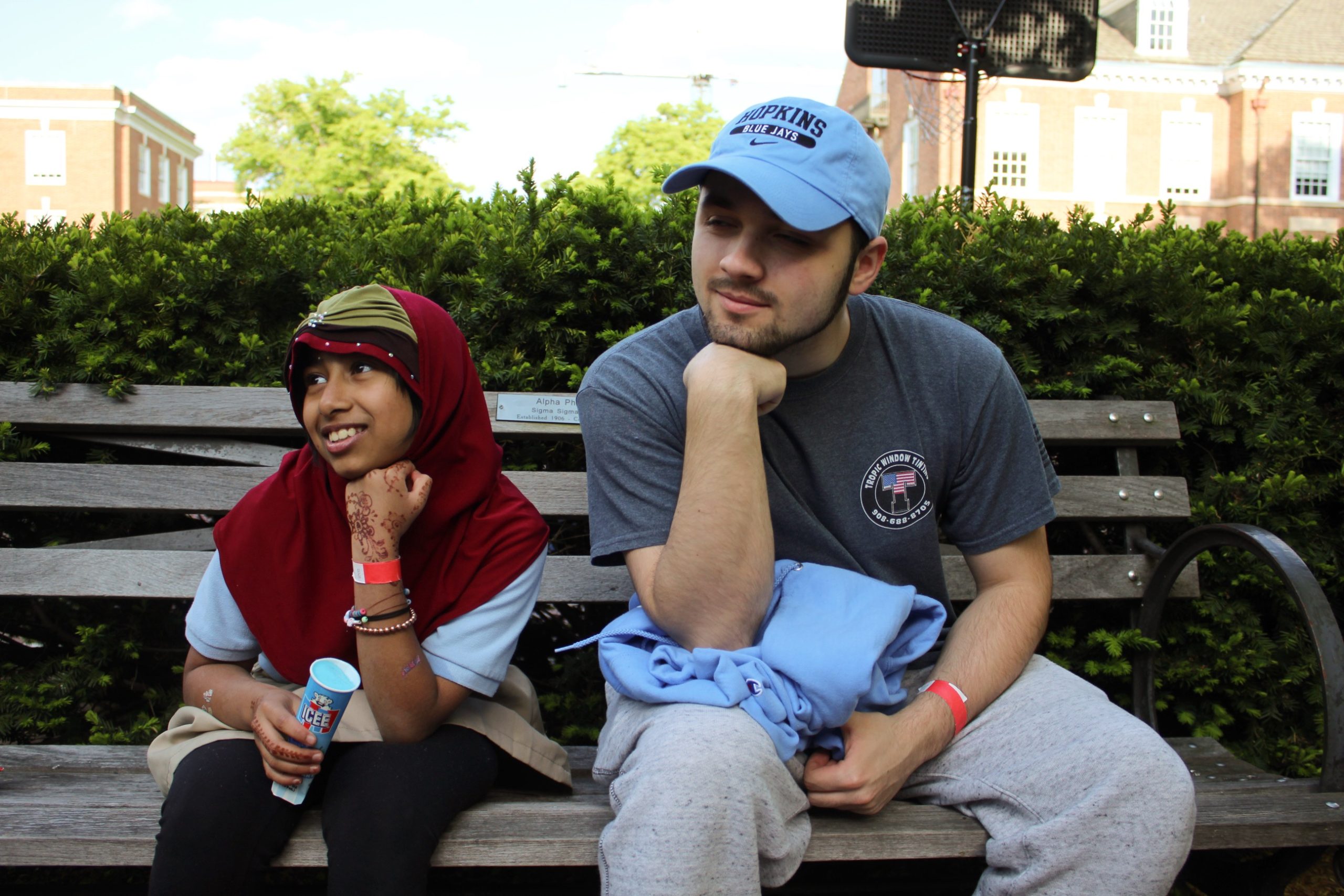 Tutor and tutee recreating the Thinker pose at the 2023 field day