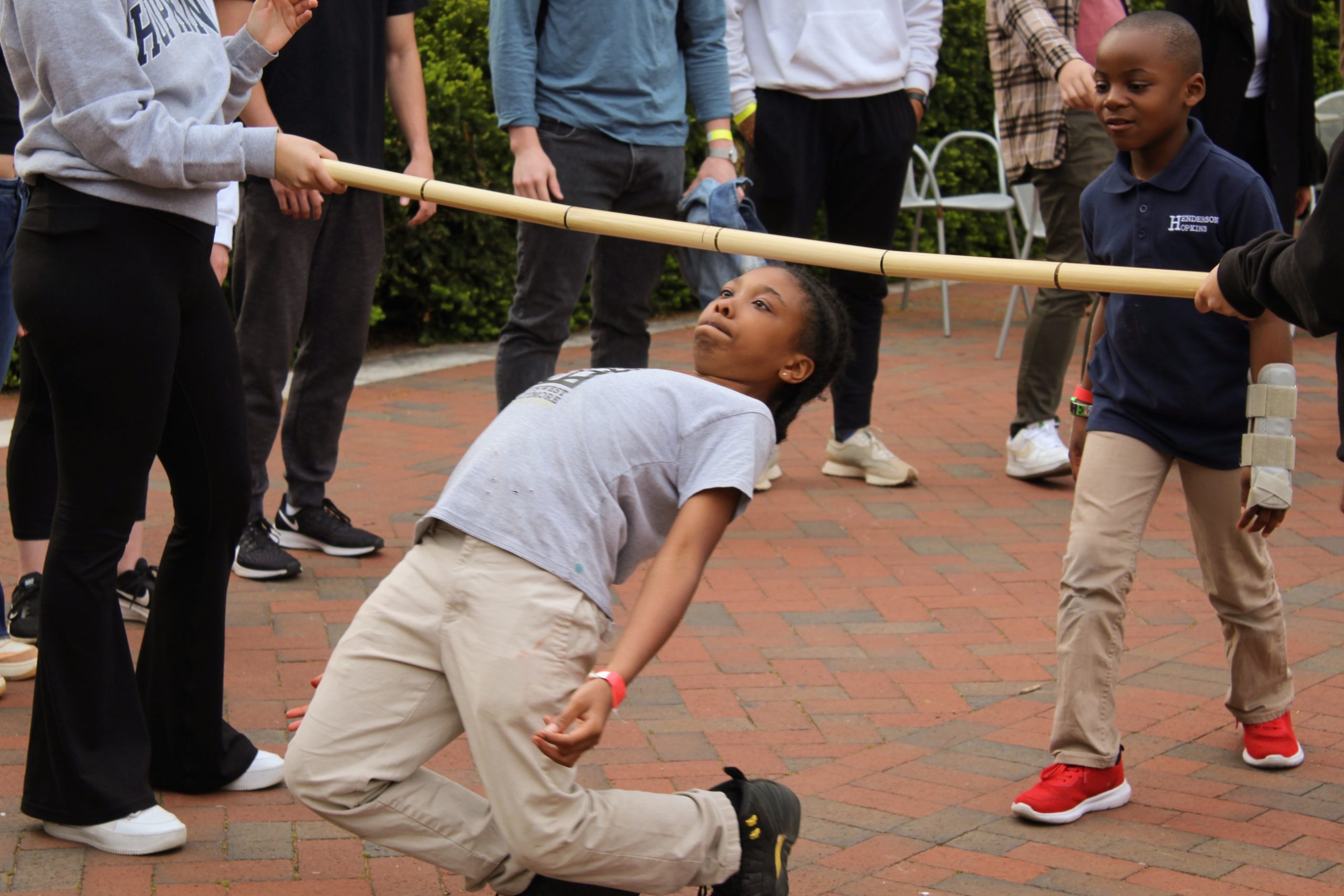 Tutee doing limbo at the 2023 field day