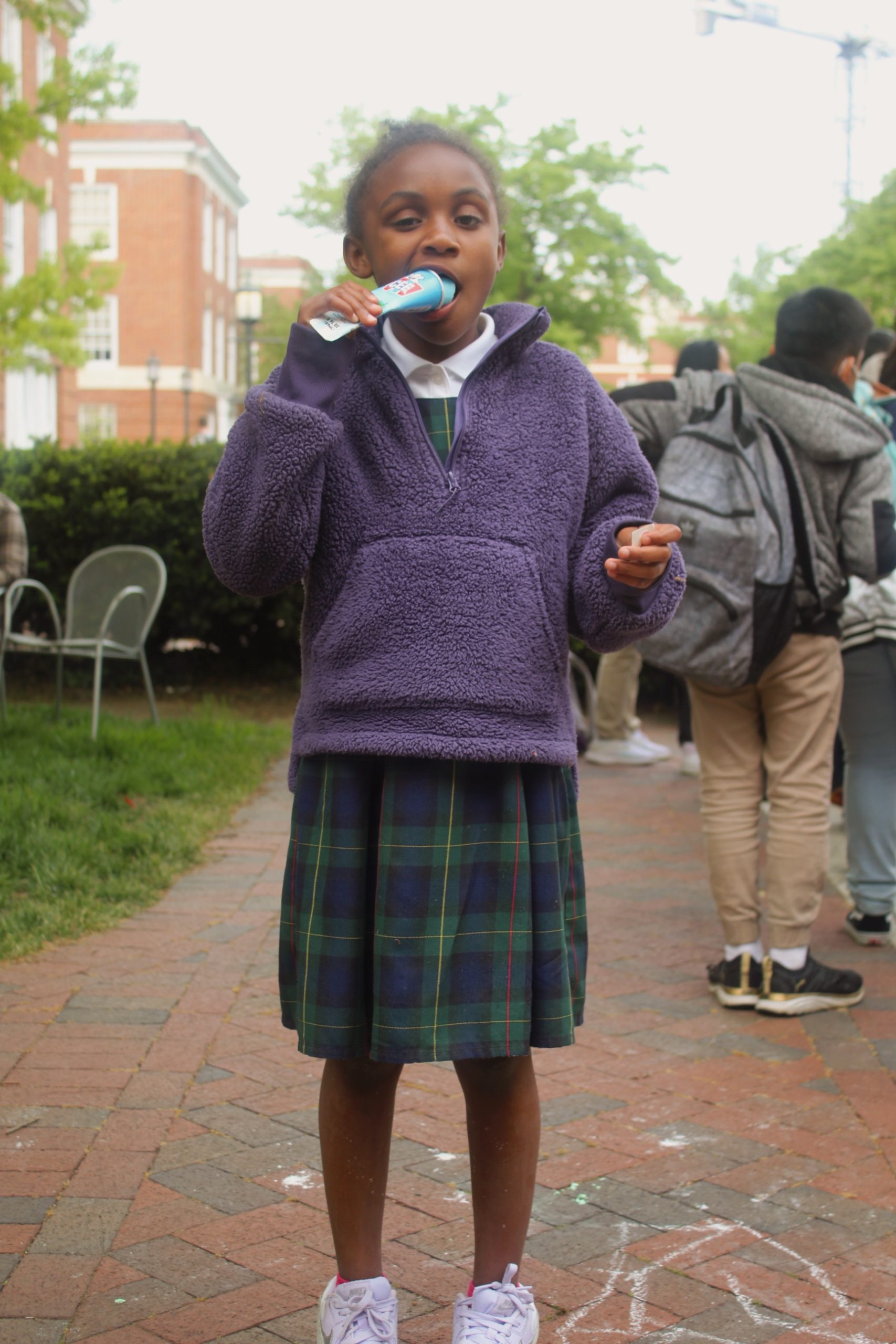 Student eating an icee at the 2023 field day