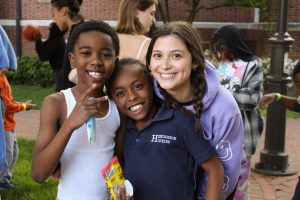 Two tutees and two tutors smiling at the 2023 field day. This is part of Tutorial Project, one of the CSC's programs.