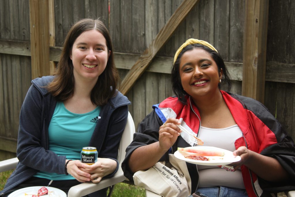Diksha and Rebecca smiling while holding up their food and minute maid lemonade