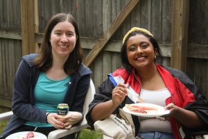 Diksha and Rebecca smiling while holding up their food and minute maid lemonade