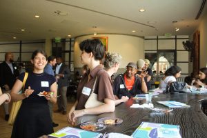 CIIP closing ceremony - picturing CIIP interns and supervisor laughing. Some are leaning against a table. 