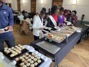Participants grabbing crab cakes and other lunch treats at the CSC MLK Day Jr. Luncheon