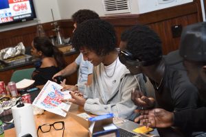 Hopkins Students filling in United States map blue or red as they watch the election