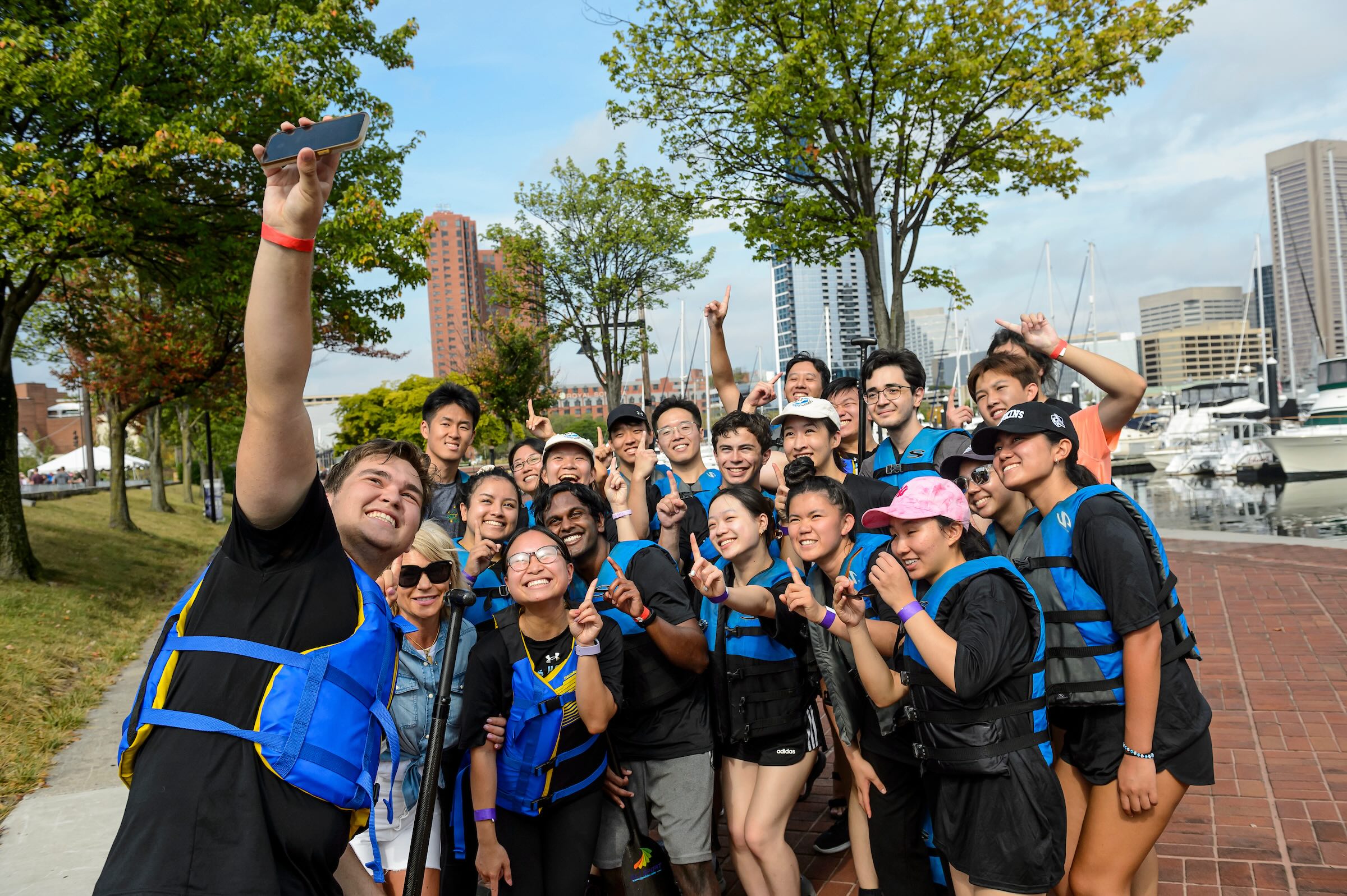 A group of students at the harbor taking a selfie