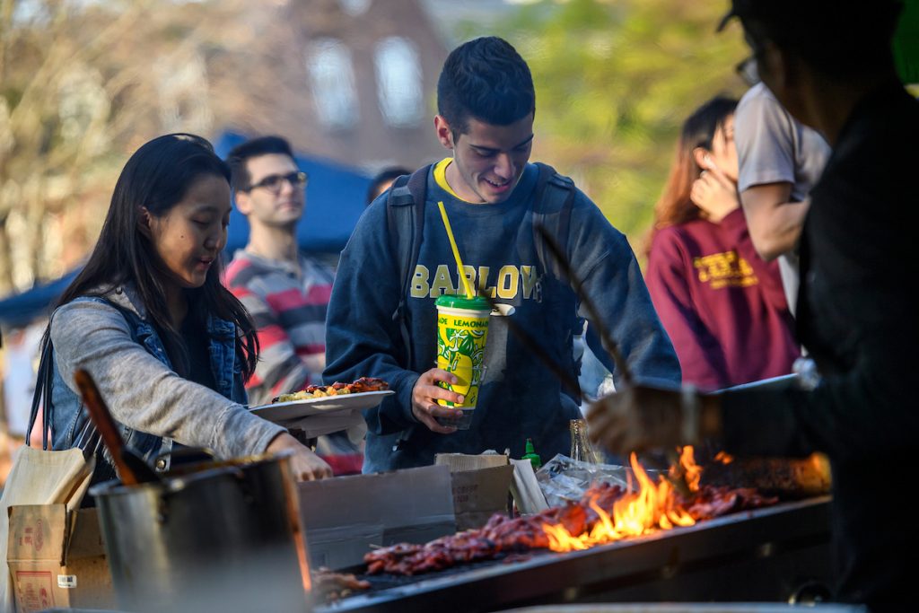 Students look at a BBQ vendor.