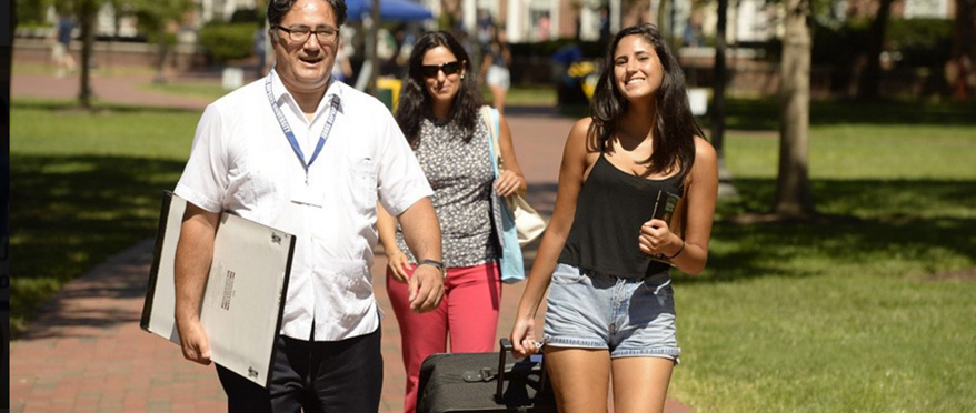 Parents and daughter heading toward dorms for move-in