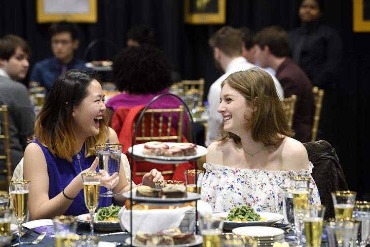 Two students laughing together at the annual First-Year Banquet.