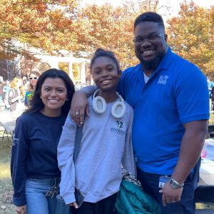 Three people smiling while posing for a photo