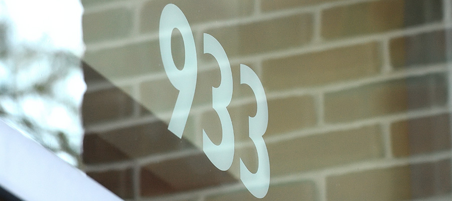 A photo of the number 933 printed on the window of University Health Services
